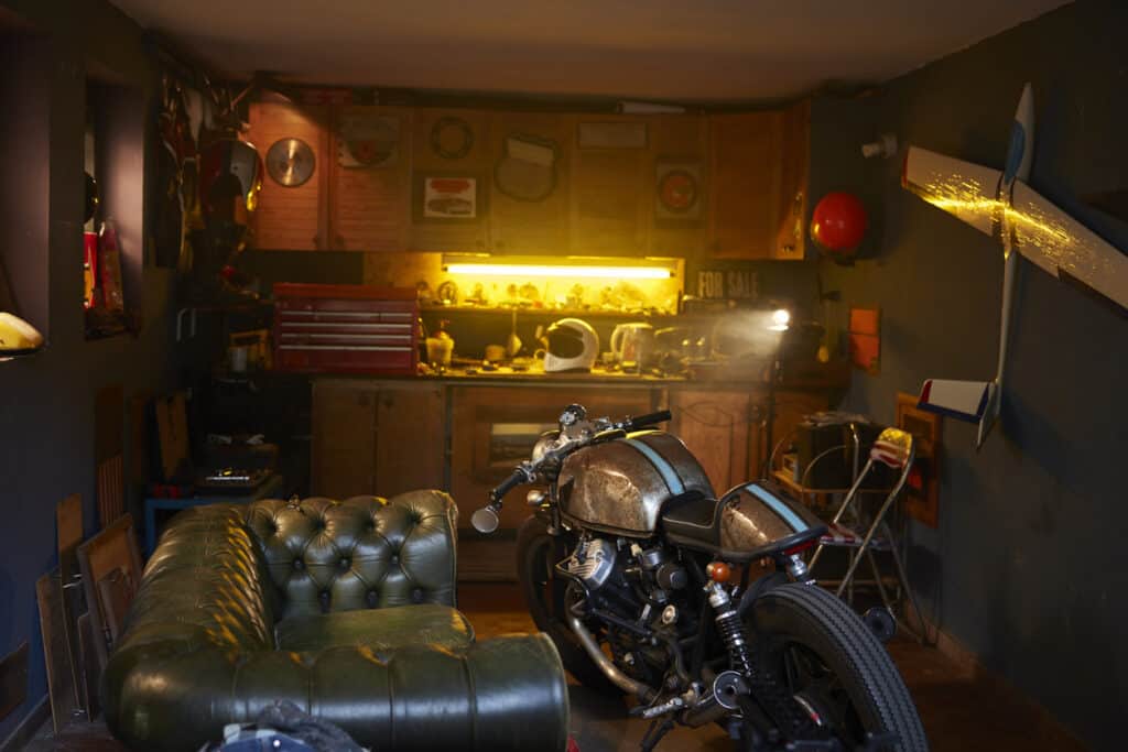Fancy motorcycle storage shed with bike and leather couch