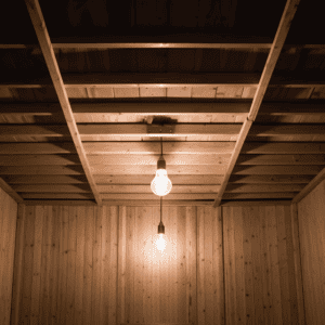 The interior of an unfinished shed with interior lighting 